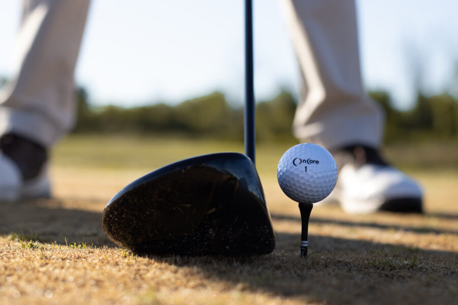 driver clubhead and golf ball close-up photo