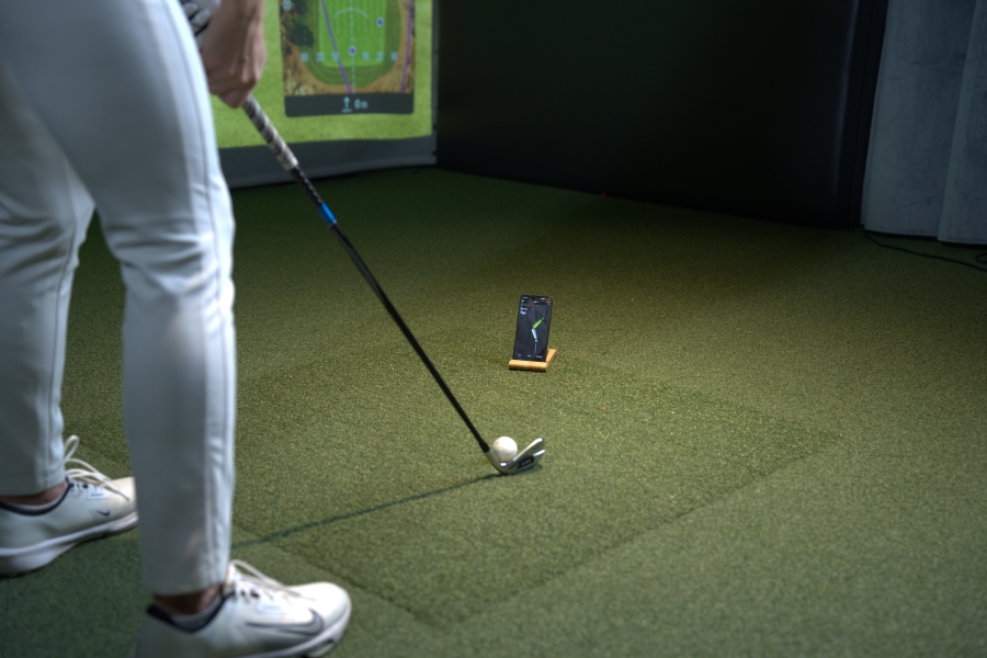 female golfer at address position training with HackMotion