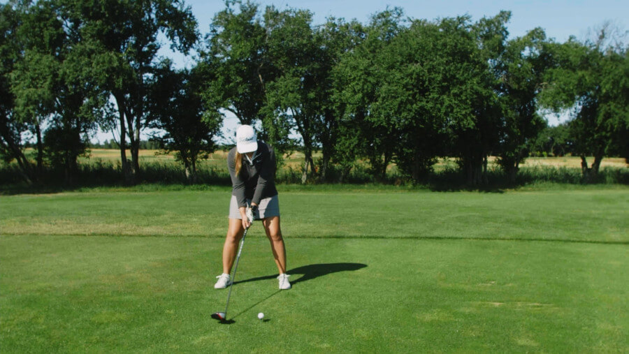 female golfer ready for golf shot image from awareness video