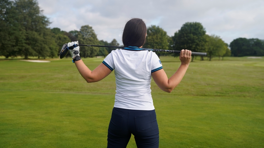 female golfer stretching before playing golf