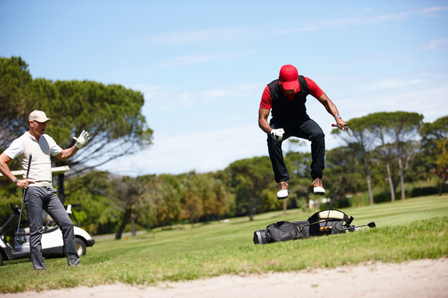 frustrated golfer jumping on his golf bag