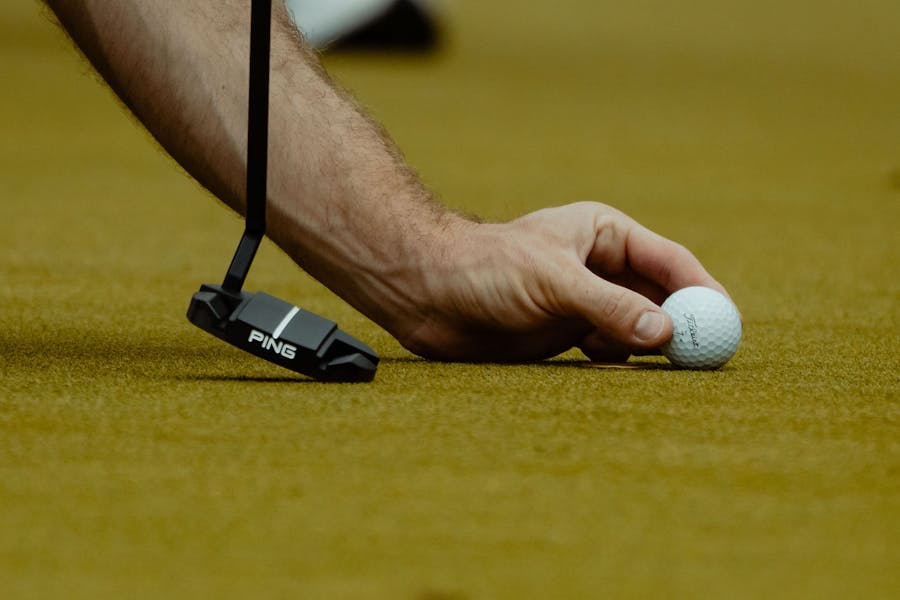 golf ball placement on green and putter
