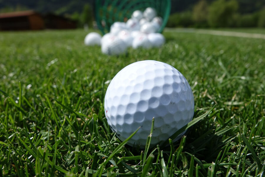 golf balls closeup at golf driving range course