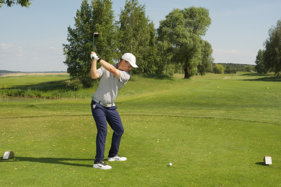 golf player ready for golf shot with driver