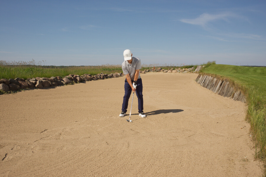 golf player ready to hit bunker shot
