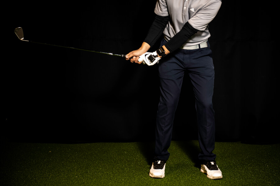 golf player training swing indoor