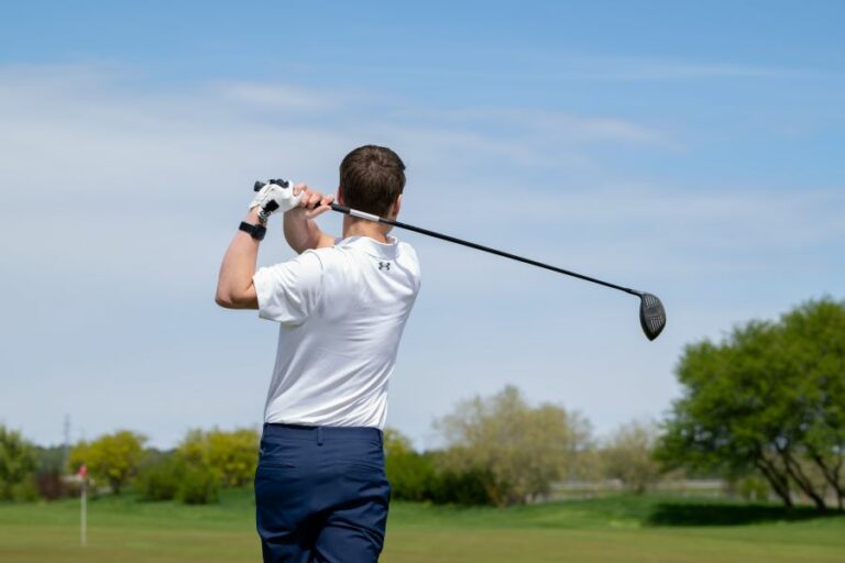 golfer finished shot with driver from tee box