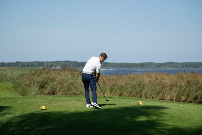 golfer hitting golf ball from tee box