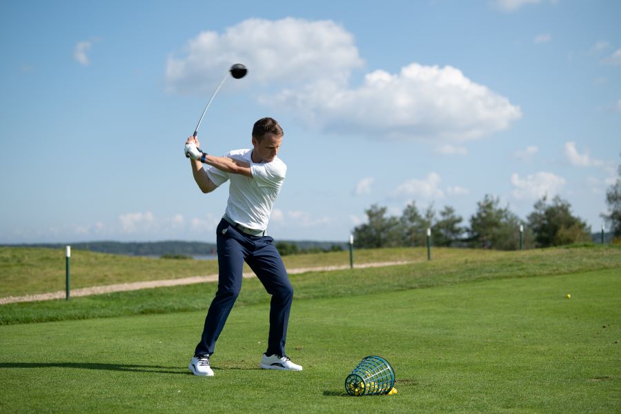 golfer hitting with driver in downswing position