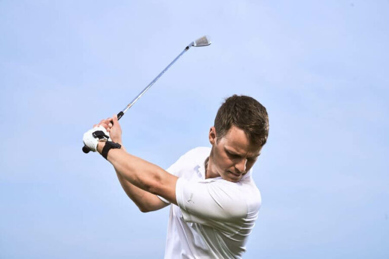 golfer hitting with iron