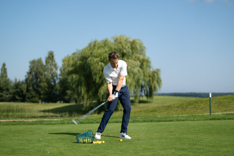 golfer on course striking ball with irons