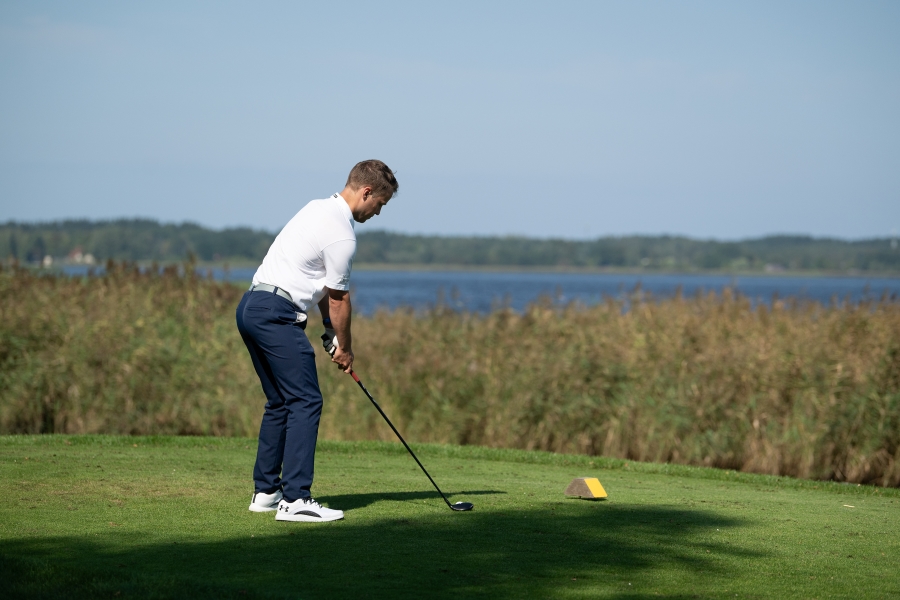 golfer on tee box ready to hit with fairway wood