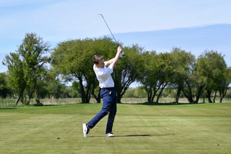 golfer on the course hitting iron golf club