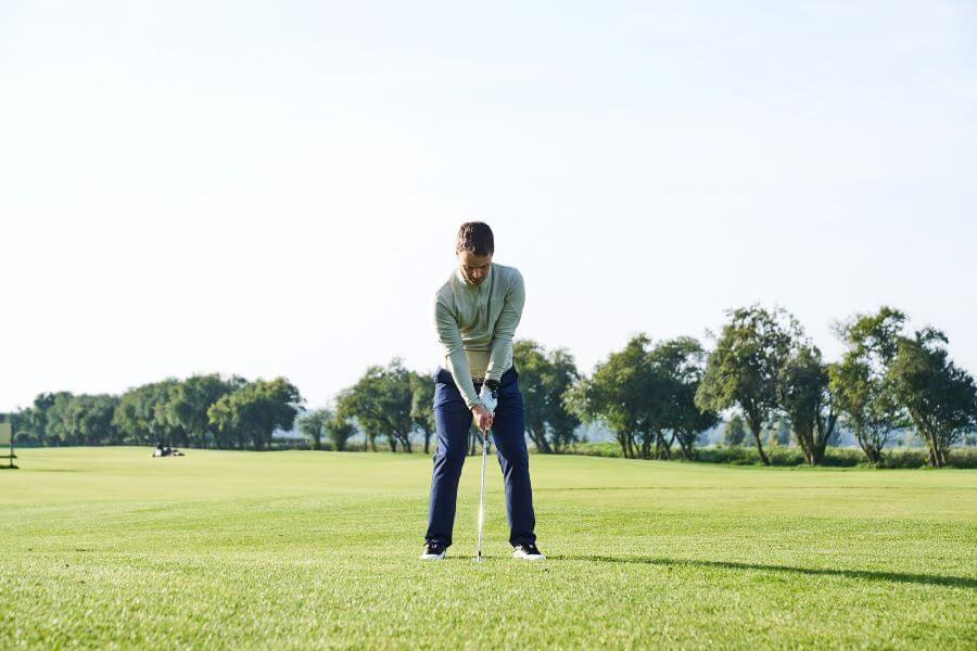 golfer ready to hit with iron - address position
