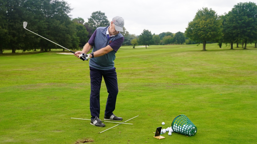 golfer training at the driving range with hackmotion wrist sensor