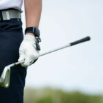 golfer wearing hackmotion wrist sensor and holding golf club