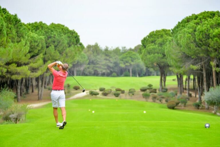 man in red top playing golf