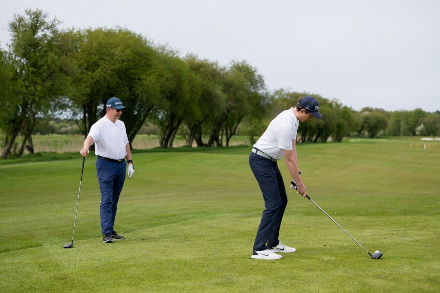 two golfers playing golf on the course