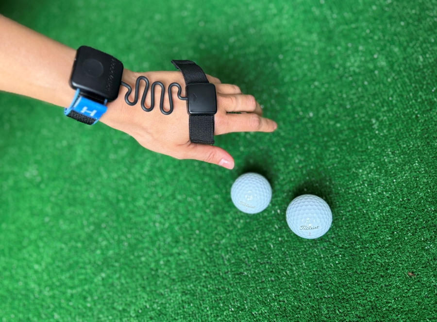 woman wearing HackMotion golf wrist sensor